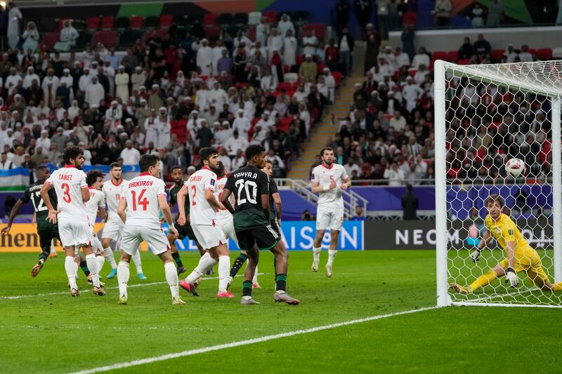 The UAE's Khalifa Al Hammadi, far left, scores his side's equaliser to take the game into extra time. AP