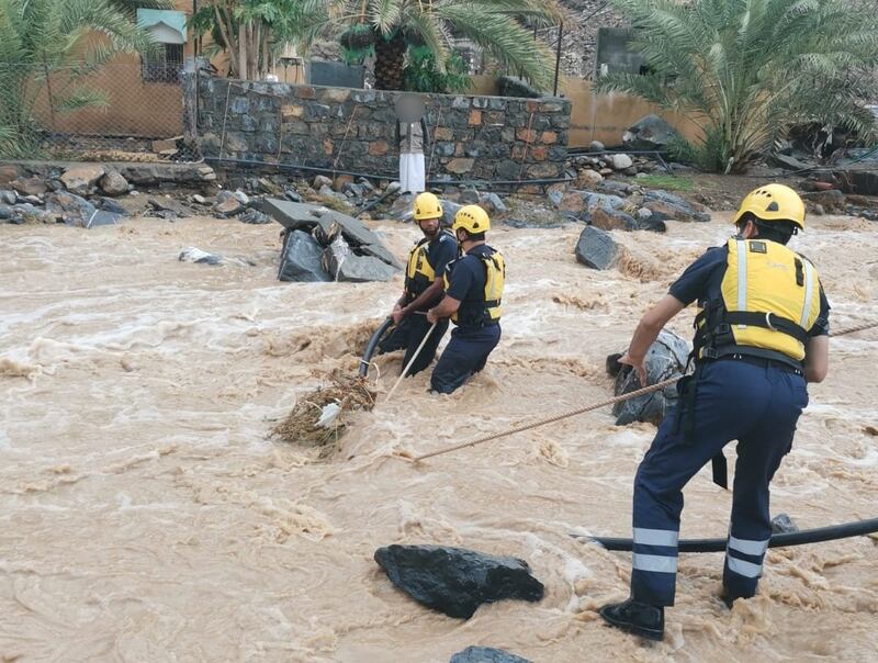 Civil defence workers prepare to rescue four people, including children, at a house surrounded by rising floodwaters near Jebel Shams. Photo: Oman Civil Defence and Ambulance Authority