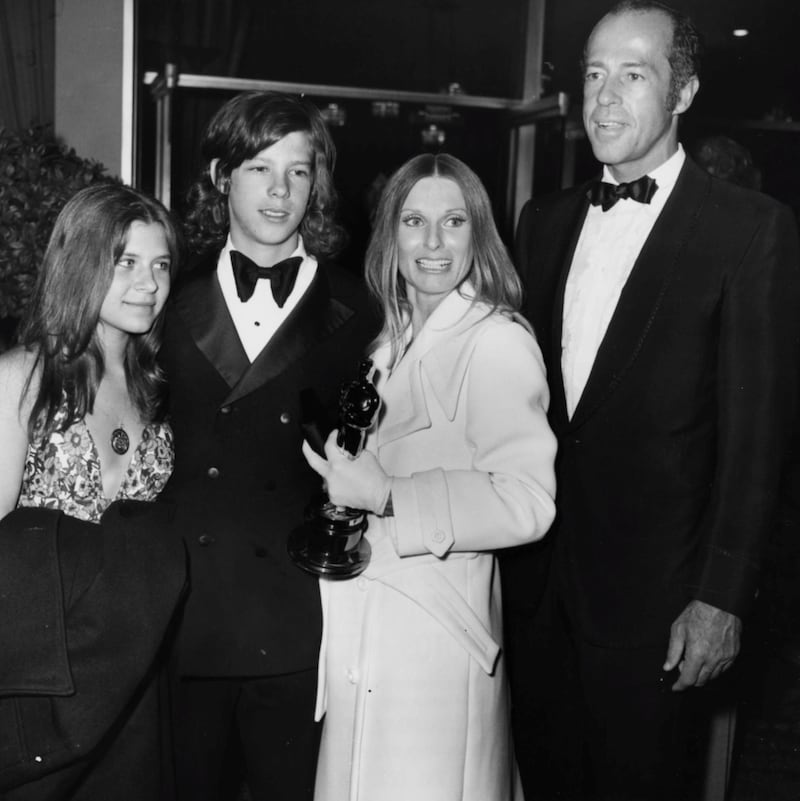 Actress Cloris Leachman, with her husband George Englund, son Brian and his girlfriend Mary, holding her award for 'The Last Picture Show' at the Academy Awards, Los Angeles, April 1972. (Photo by Fotos International/Archive Photos/Getty Images)