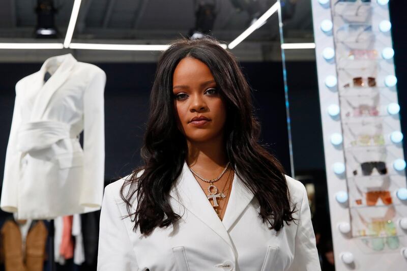 Singer Rihanna, the first black woman in history to head up a major Parisian luxury house, poses as she unveiled her first fashion designs for Fenty at a pop-up store in Paris, France, Wednesday, May 22, 2019. The collection, named after the singer turned designer's last name, comprises ready-to-wear, footwear, accessories, and eyewear and is available for sale Paris' Le Marais area from Friday and will debut online May 29. (AP Photo/Francois Mori)