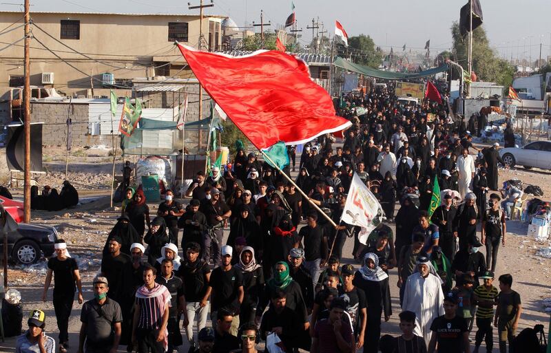 Shi'ite Muslim pilgrims walk to the holy city of Kerbala, ahead of the holy Shi'ite ritual of Arbaeen, amid the outbreak of the coronavirus disease (COVID-19), in Kerbala, Iraq October 6, 2020. REUTERS/Alaa Al-Marjani