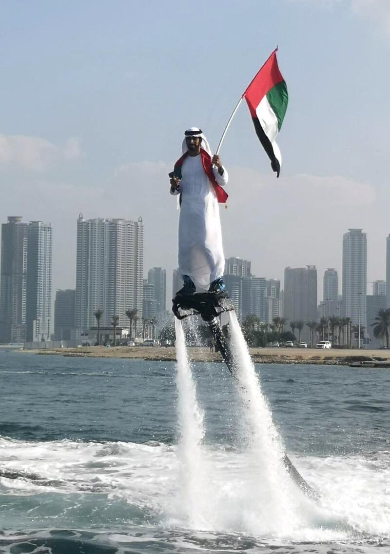 An Emirati man performs tricks on a flyboard at the Sharjah Maritime Museum, as part of National Day festivities. Salam Al Amir / The National