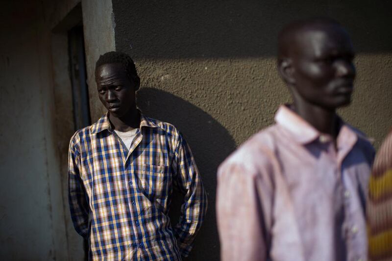 Steven Nyah, 23, who says he deserted the Sudan People’s Liberation Army (SPLA), stands outside a police station in Mvolo. Thirteen deserters from the SPLA are being held in Mvolo by district authorities. One month of fighting in South Sudan. Phil Moore / AFP Photo
