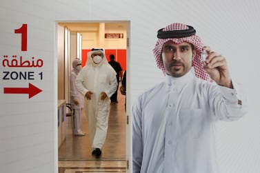 A man leaves a clinic in Manama, Bahrain, after receiving a vaccine dose. Reuters