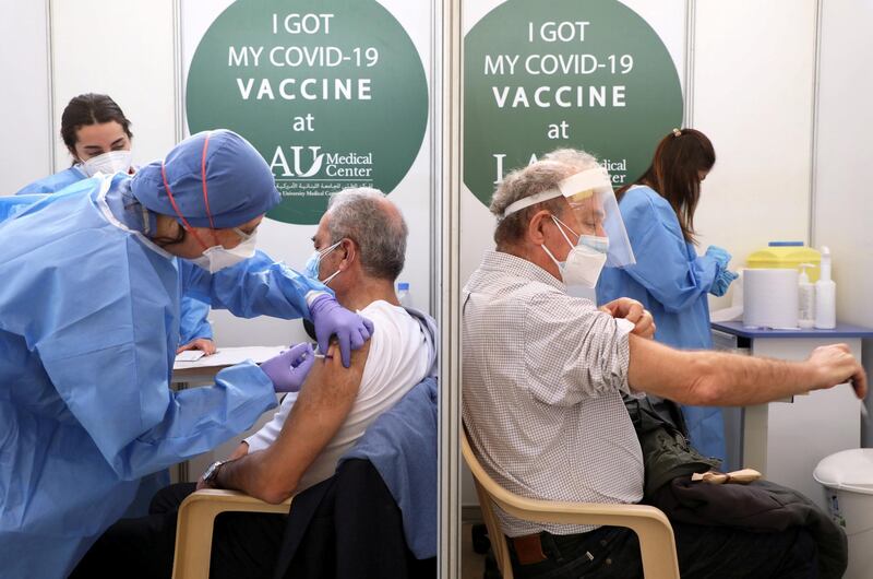 Men receive a Pfizer/BioNTech COVID-19 vaccine dose during a coronavirus vaccination campaign at Lebanese American University Medical Center-Rizk Hospital in Beirut, Lebanon February 16, 2021. REUTERS/Mohamed Azakir