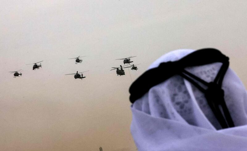 A man watches as helicopters demonstrate their skills during the Union Fortress 8 military parade. AFP