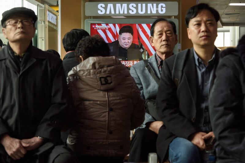 A television screen shows a news broadcast of Kim Jong Un meeting with Donald Trump during their summit in Hanoi, at a railway station in Seoul, South Korea. AFP