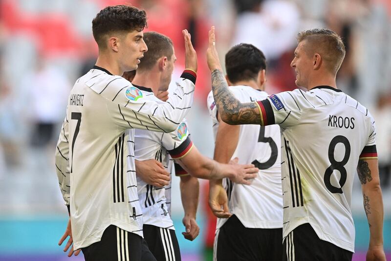 TOPSHOT - Germany's forward Kai Havertz (L) celebrates with Germany's midfielder Toni Kroos after scoring his team's third goal during the UEFA EURO 2020 Group F football match between Portugal and Germany at Allianz Arena in Munich, Germany, on June 19, 2021. / AFP / POOL / PHILIPP GUELLAND
