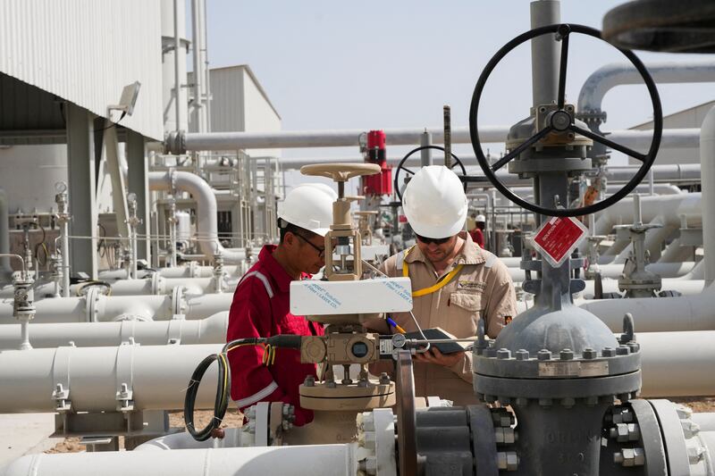Workers work at Majnoon oil field near Basra, Iraq, in May. Reuters