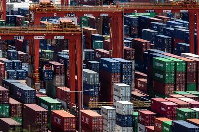 Shipping containers are seen stacked on top of each other at a cargo terminal in Hong Kong on July 18, 2020.  / AFP / ISAAC LAWRENCE

