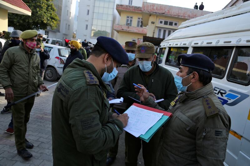 Police officers record details of those who died in the stampede at the shrine.  AP Photo