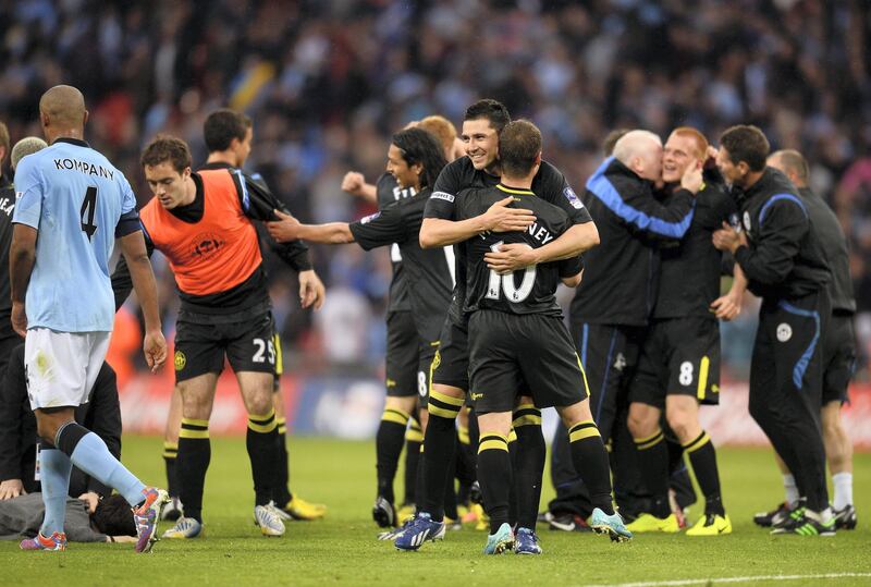 LONDON, ENGLAND - MAY 11:  Wigan Athletic players celebrate victory after the FA Cup with Budweiser Final between Manchester City and Wigan Athletic at Wembley Stadium on May 11, 2013 in London, England.  (Photo by Mike Hewitt/Getty Images)