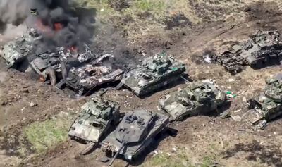 Leopard tank and Bradley infantry fighting vehicles destroyed in an early Ukraine attack. EPA