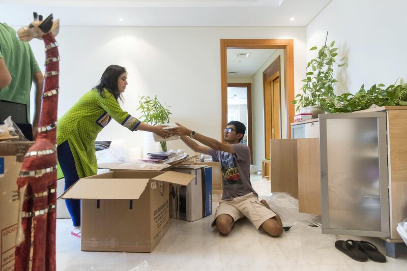 Dubai, United Arab Emirates, September 7, 2017:    Meena Jain and her son Tanish, 18, move their belongings back into their flat on the 29th floor of the Tamweel Tower in the Jumeirah Lake Towers area of Dubai on September 7, 2017. Jain and her family bought their flat and were sent to move in a week before the 2012 fire that gutted the upper floors of Tamweel Tower. Christopher Pike / The National

Reporter: Ramola Talwar
Section: News