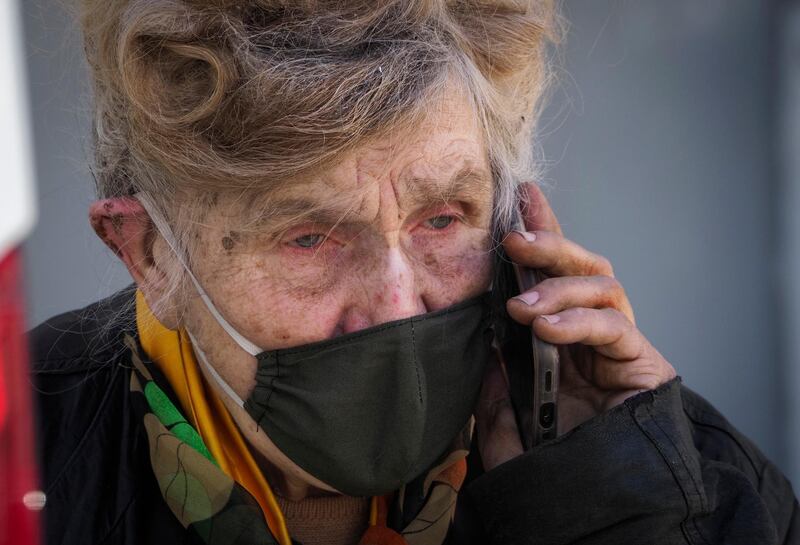 Galina Yakovleva, 80, speaks to a recipient of her aid deliveries in St Petersburg, Russia. AP Photo