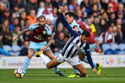 West Bromwich Albion's Hal Robson-Kanu (centre) goes to ground after a challenge by Burnley's Jack Cock (right) during the Premier League match at Turf Moor, Burnley. PRESS ASSOCIATION Photo. Picture date: Saturday August 19, 2017. See PA story SOCCER Burnley. Photo credit should read: Anthony Devlin/PA Wire. RESTRICTIONS: EDITORIAL USE ONLY No use with unauthorised audio, video, data, fixture lists, club/league logos or "live" services. Online in-match use limited to 75 images, no video emulation. No use in betting, games or single club/league/player publications.