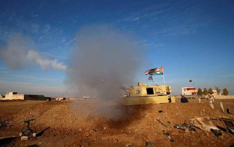 Iraqi army personnel fire toward Islamic State militants, during clashes, north of Mosul.