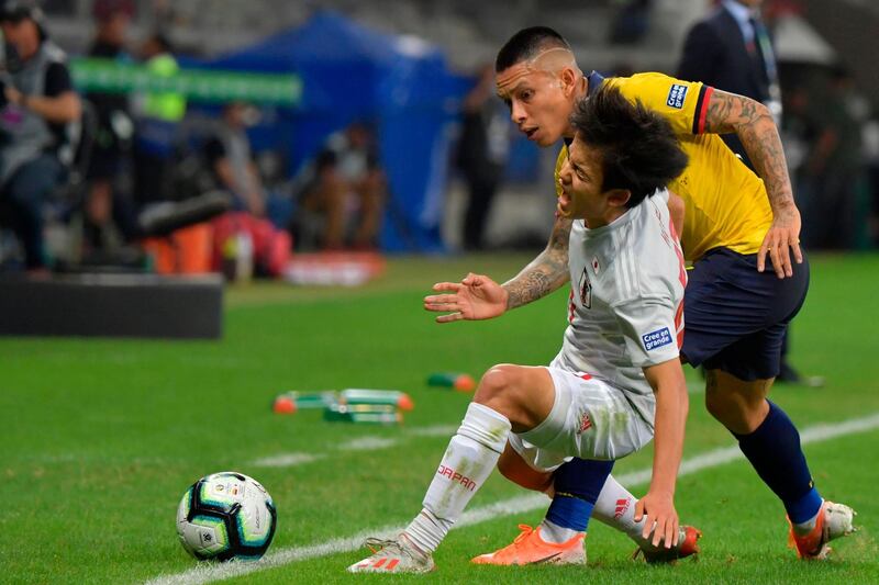 Japan's Takefusa Kubo and Ecuador's Cristian Ramirez vie for the ball. AFP