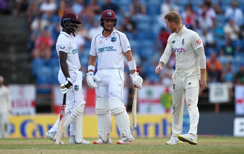 Ben Stokes of England speaks to West Indies batsmen Joshua Da Silva and Kemar Roach. Getty