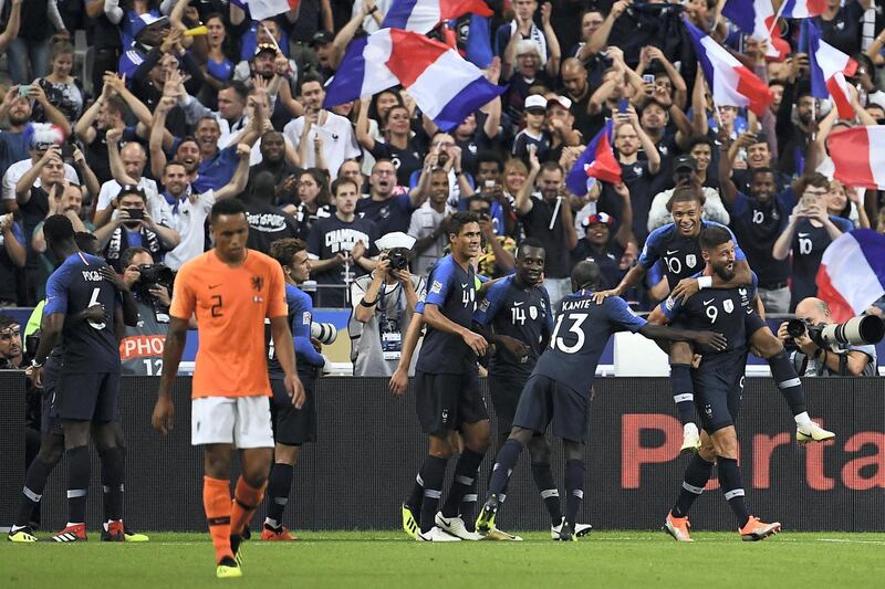 France's forward Olivier Giroud celebrates with teammates after scoring a goal during the UEFA Nations League football match between France and Netherlands at the Stade de France stadium, in Saint-Denis, northern of Paris, on September 9, 2018. / AFP PHOTO / Anne-Christine POUJOULAT