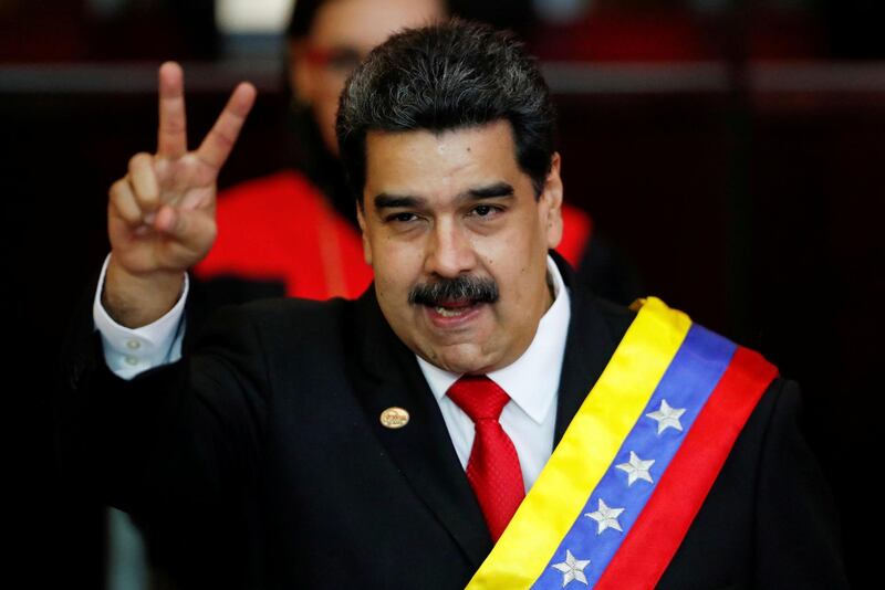 FILE PHOTO: Venezuelan President Nicolas Maduro gestures after receiving the presidential sash during the ceremonial swearing-in for his second presidential term, at the Supreme Court in Caracas, Venezuela Jan. 10, 2019. REUTERS/Carlos Garcia Rawlins//File Photo