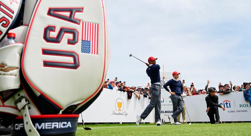 Tiger Woods of the US (C) tees off during a practice round ahead of the Presidents Cup. AFP