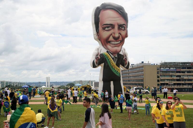 Supporters of Brazil's President-elect Jair Bolsonaro arrive to watch his inauguration ceremony. Reuters