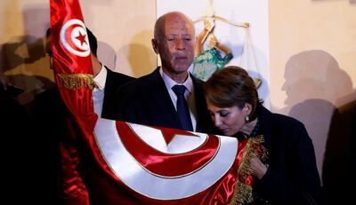 Tunisian presidential candidate Kais Saied and his wife Ichraf Chebil react after exit poll results were announced in a second round runoff of the presidential election in Tunis, Tunisia October 13, 2019. REUTERS/Zoubeir Souissi