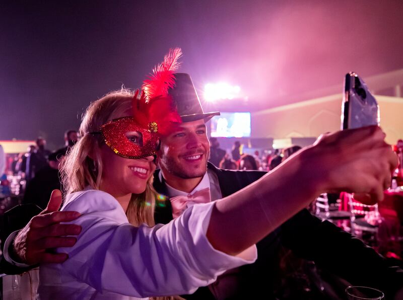 Guests take selfies at the New Year's Eve gala dinner.