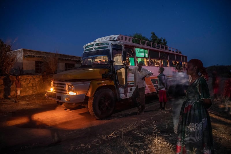People who fled the conflict in Ethiopia's Tigray region, arrive on a bus at Umm Rakouba refugee camp in Qadarif, eastern Sudan. AP