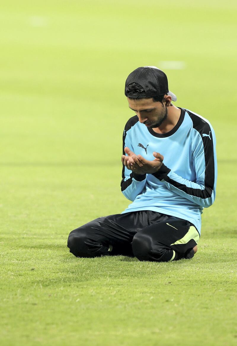 Players pray before the Sharjah Ramadan Cup game between MGM Cricket Club v Pacific Group in Sharjah on April 27th, 2021. Chris Whiteoak / The National. 
Reporter: Paul Radley for Sport