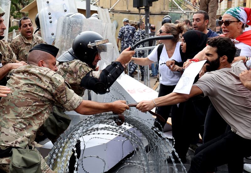 Lebanese activists confront soldiers guarding the entrance of the country's parliament building during a demonstration in Beirut on Thursday. AFP