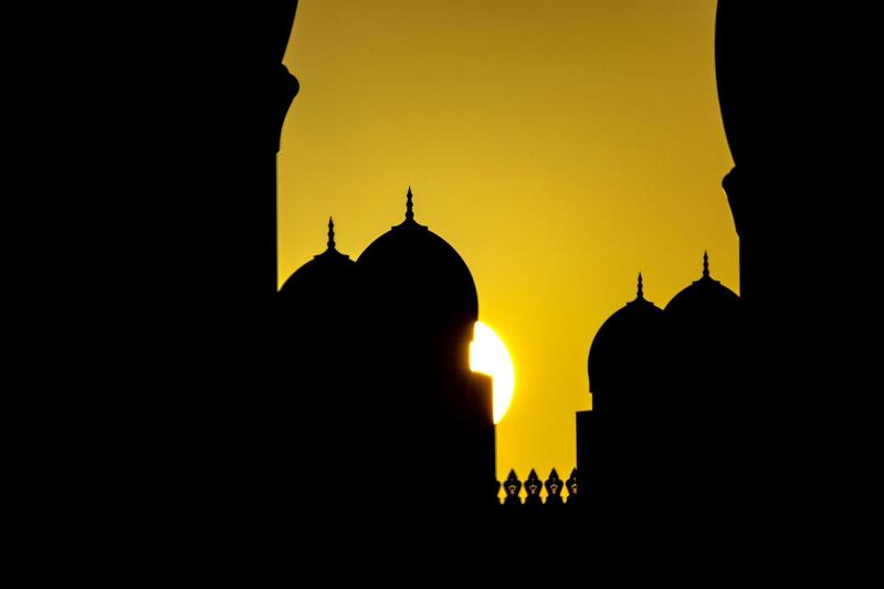 The sun rises behind the Sheikh Zayed Grand Mosque in Abu Dhabi on June 2nd, 2021. Victor Besa / The National.