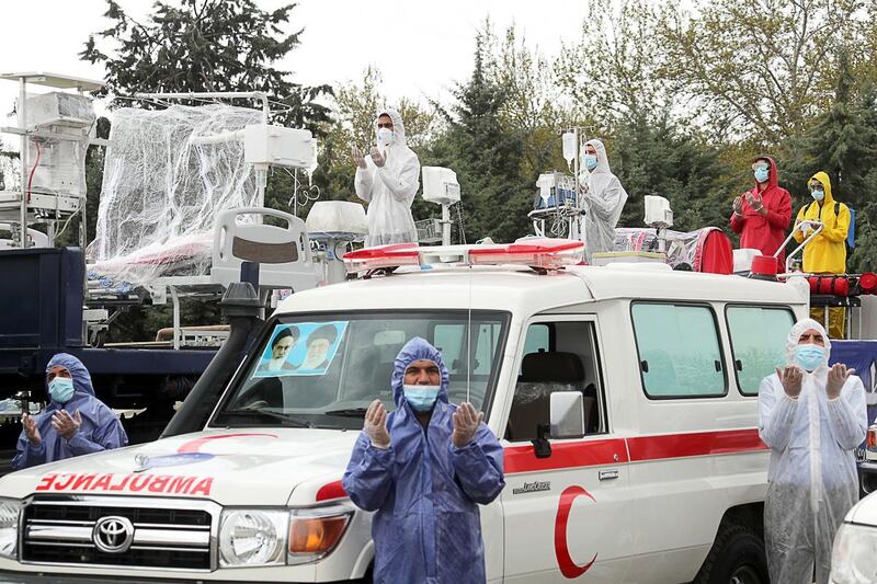 Iranian army soldiers wearing protective face masks parade with disinfection equipment to mark National Army Day in Tehran on April 17, 2020. Iranian military via EPA, HO