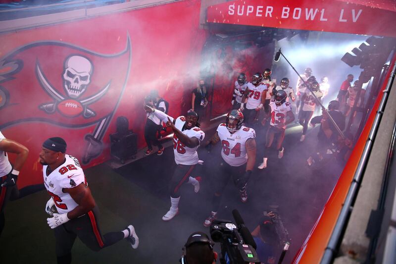 Tampa Bay Buccaneers players run to the field as they are introduced before Super Bowl LV against the Kansas City Chiefs at Raymond James Stadium. Reuters