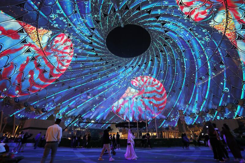 Visitors watch an immersive show at Al Wasl dome. Pawan Singh / The National  