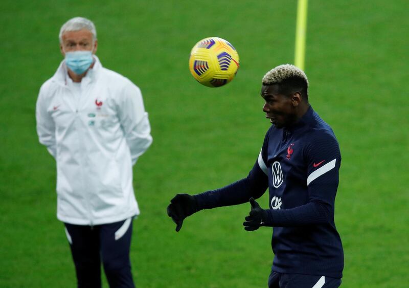 Paul Pogba takes part in a training session at the Stade de France as Didier Deschamps watches on. Reuters