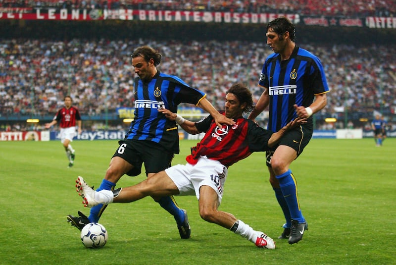 AC Milan's Rui Costa battles with Cristiano Zanetti, left, and Massimo Materazzi of Inter Milan during the semi-final  second leg. Getty