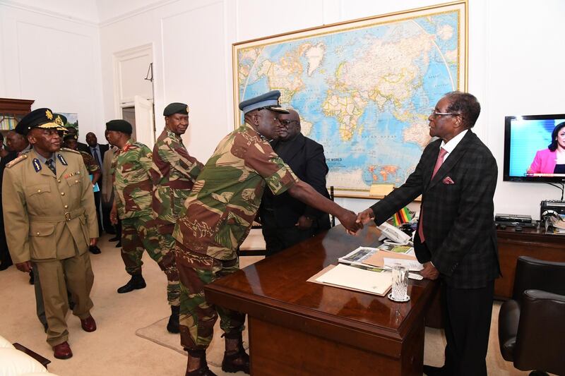 epa06340268 A handout photo made available by the Zimbabwean government through 'The Herald' daily newspaper on 20 November 2017 shows Zimbabwean President Robert Mugabe (R) greeting the Air Force of Zimbabwe Commander Perence Shiri (C) before a meeting with the country's military and security chiefs at the State House in Harare, Zimbabwe, 19 November 2017. Others are not identified. Mugabe in the broadcasted address declared that he plans to remain the country's president. Media reports that the deadline set by the the ruling Zanu-PF party for Robert Mugabe to resign has past on 20 November 2017 and later in the day Zanu-PF will meet to discuss the possible impeachment of President Mugabe.  EPA/THE HERALD HANDOUT  HANDOUT EDITORIAL USE ONLY/NO SALES