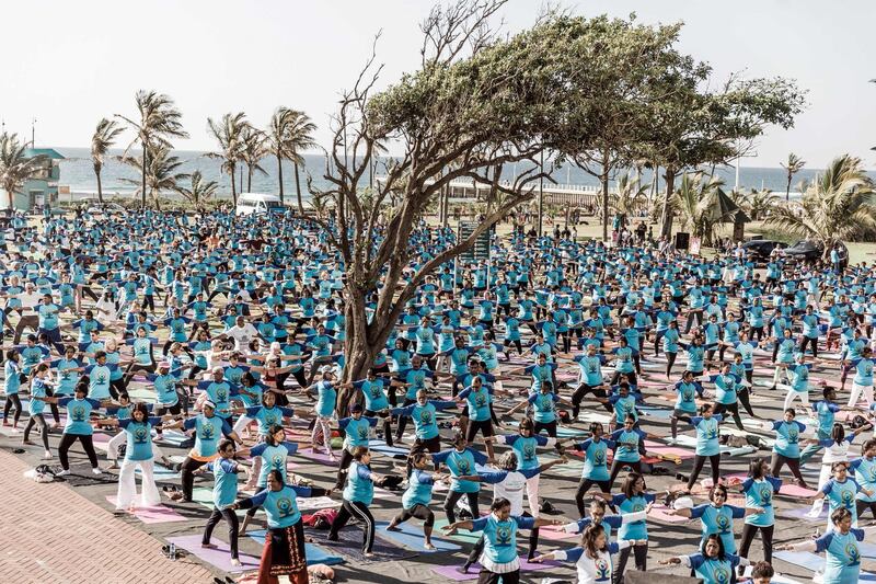Hundreds of people take part in a yoga session at North Beach in Durban, South Africa.  Rajesh Jantilal / AFP