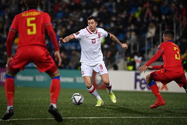 Poland's forward Robert Lewandowski(C) challenges Andorra's defender Albert Alavedra (L) during the FIFA World Cup Qatar 2022 qualification Group I 1st round football match Andorra vs Poland in Andorra la Vella on November 12, 2022.  (Photo by Valentine CHAPUIS  /  AFP)