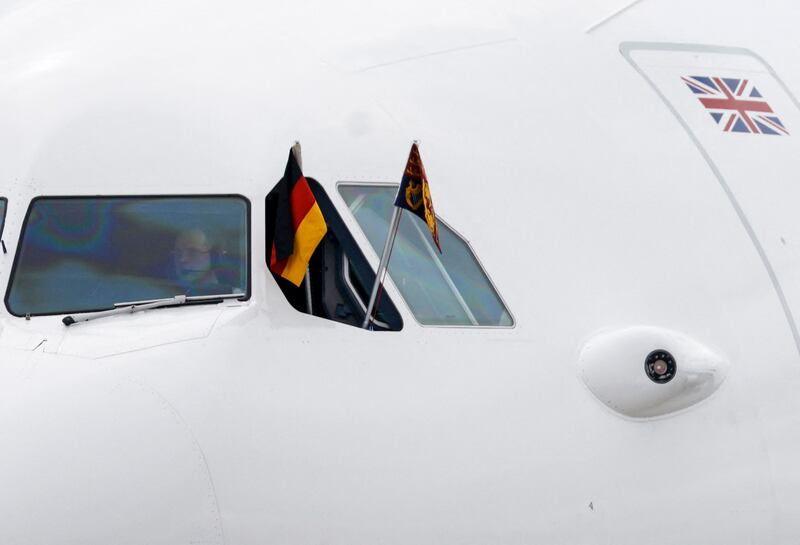 The German flag and the Royal Standard of the UK fly from the plane carrying King Charles. AFP