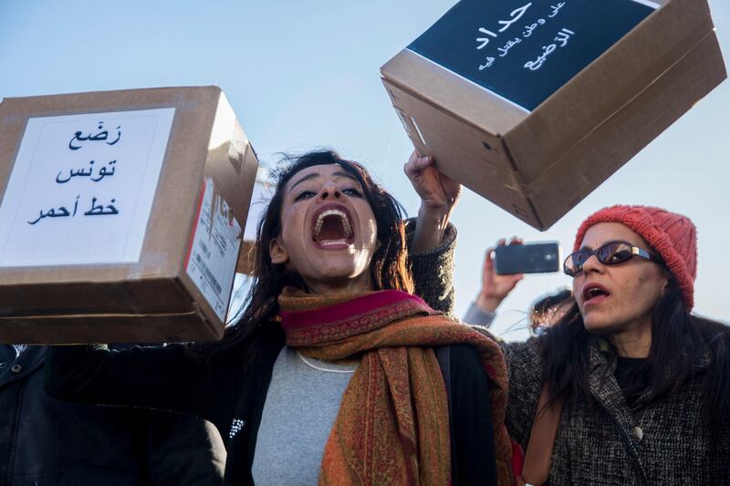 Tunisian demonstrators hold up boxs that read: "Tunisian's babies are an uncrossable line" in Tunis to denounce the deaths of twelve babies after acquiring infections at the public maternity hospital where they were born prematurely.  AP