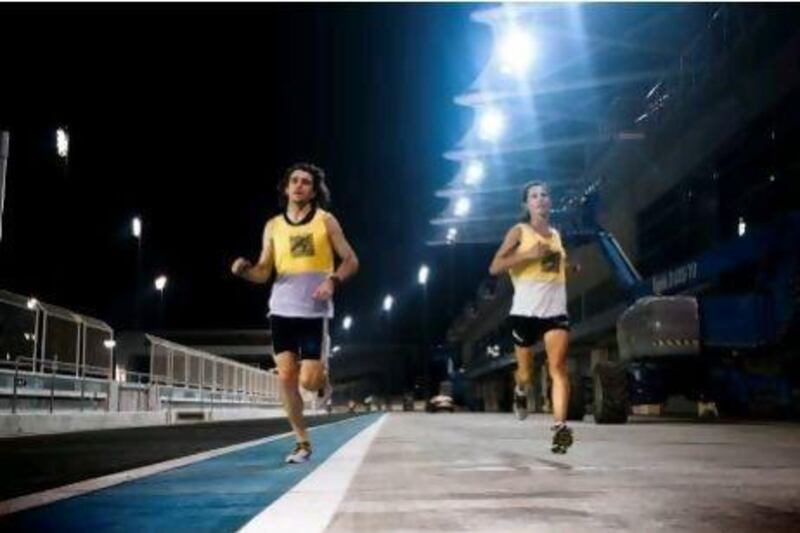 Sean Stewart and Connie Bouverot of the Abu Dhabi Striders running at Yas Circuit. Lee Hoagland / The National