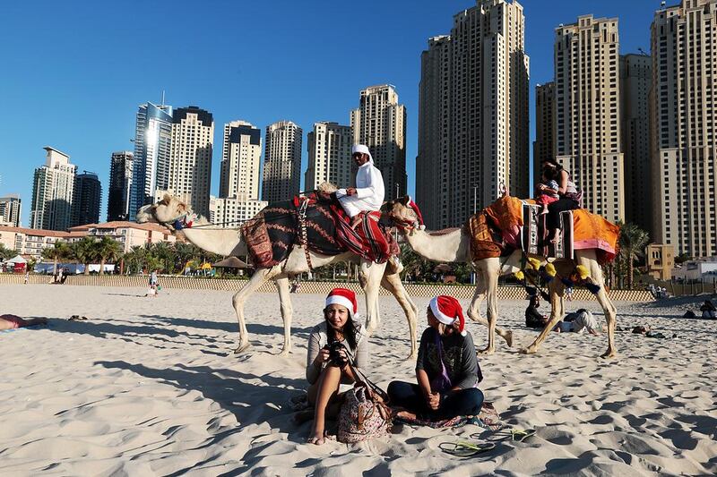 Santa hats and camels on Jumeirah Beach in Dubai in 2013. Christopher Pike / The National