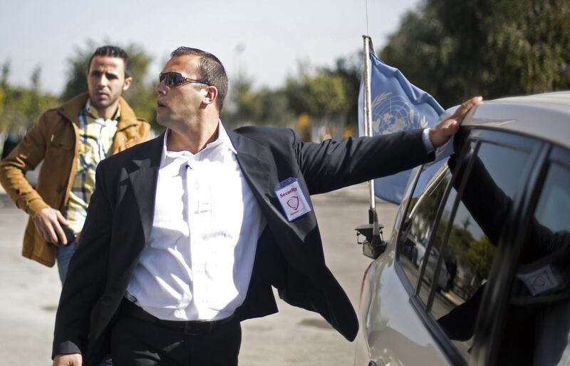 A private guard from Gaza’s first private security company stands guard near the car carrying Palestinian singer and Arab Idol winner Mohammed Assaf.