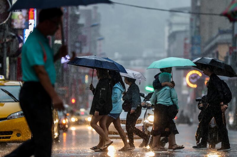 People cross the street under the rain as typhoon Mitag is expected to hit northern Taiwan, in Keelung, Taiwan. According to report, Typhoon Mitag will disrupt air, land and water traffic. Mitag is located at sea about 290 kilometers off the south-southeast of Yilan County, moving at 27 kilometers per hour at a northwesterly direction, with maximum sustained winds of 126 kilometers per hour, with gusts of up to 162 kilometers per hour, and with a radius of 180 kilometers, according to Taiwan Central Weather Bureau.  EPA