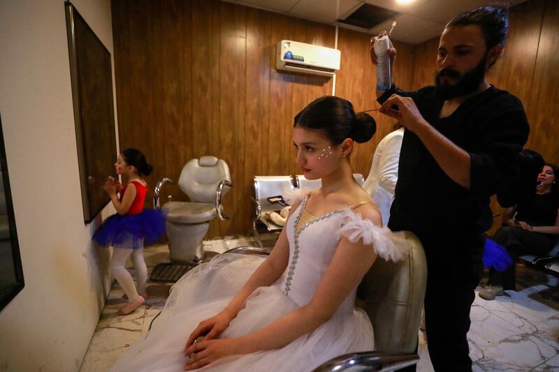 Dancers from the academy get ready backstage before their performance. AFP