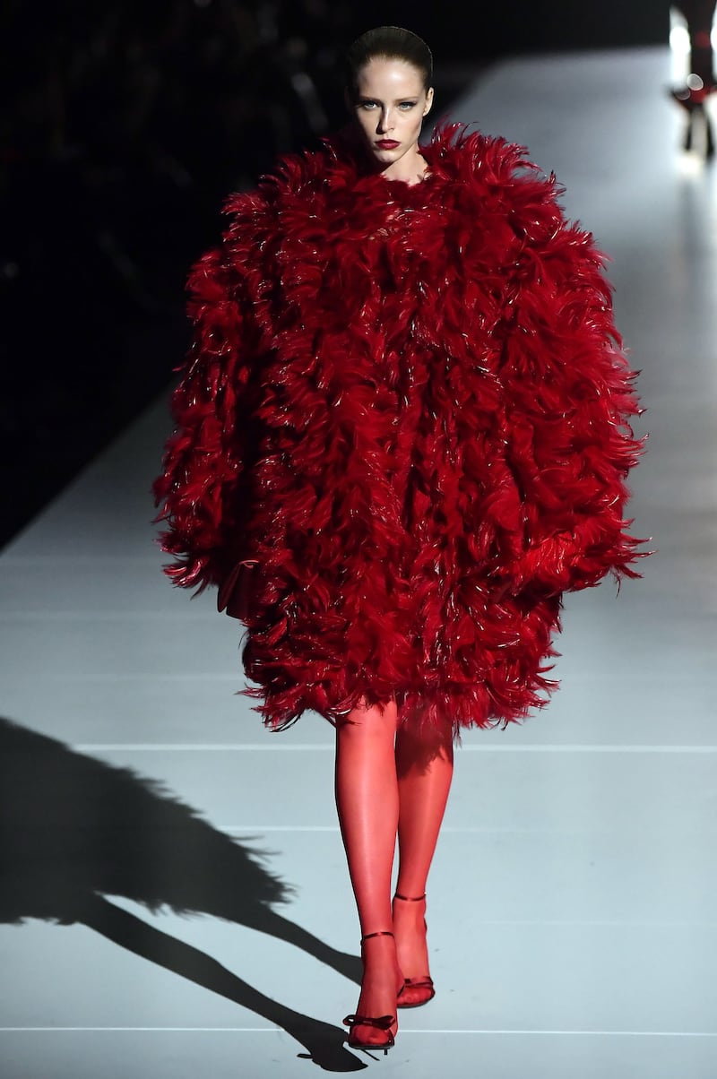 An oversized feather coat at Dolce & Gabbana. The whole collection used only four colours - red, white, black and gold. EPA
