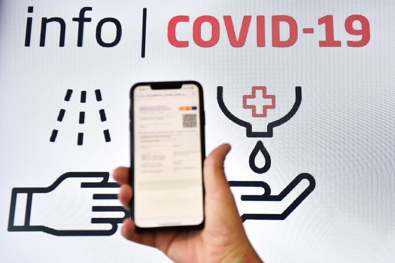 A man checks his EU digital covid certificate on his mobile phone at El Prat Airport in Barcelona, Spain.